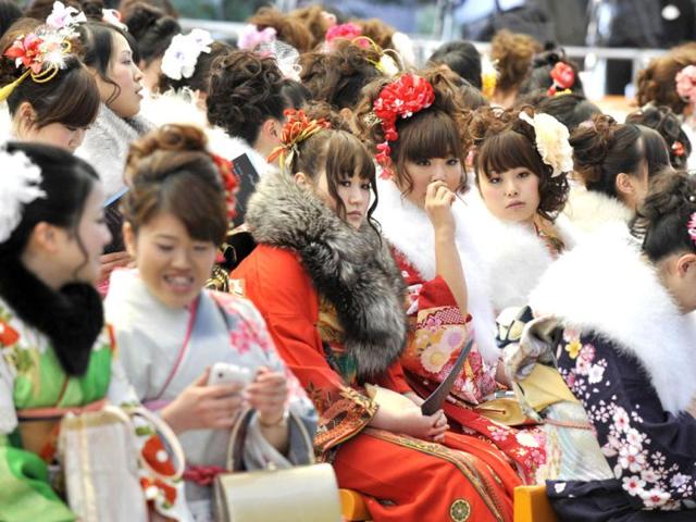 Women wearing kimonos attend the annual coming-of-age day ceremony hosted by Urayasu city at the Tokyo Disneyland. (AFP Photo/Kazuhiro Nogi)