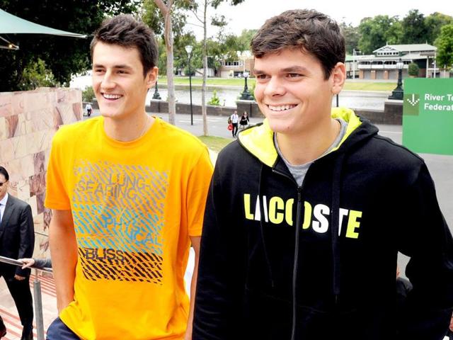 Tennis players Bernard Tomic of Australia (L) and Milos Raonic of Canada (R) arrive for a public event for the upcoming Kooyong Classic, in Melbourne. (AFP Photo/William West)