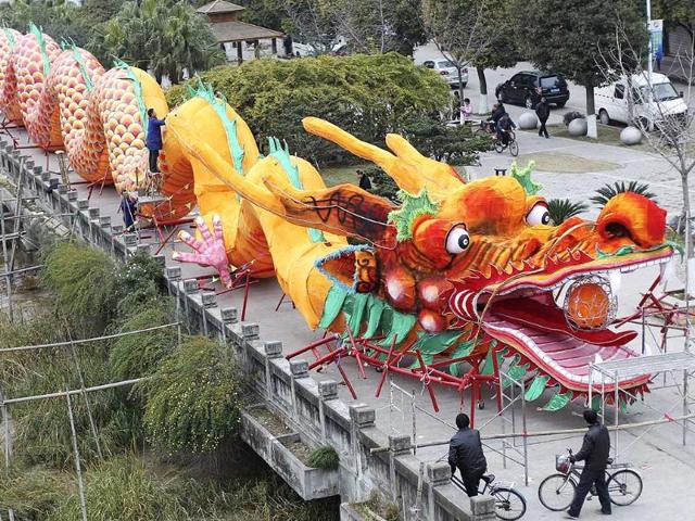 Workers decorate a dragon-shaped sculpture in preparation for a dragon dance which will involve more than 200 people during the upcoming Chinese New Year in Wenzhou, Zhejiang province. Reuters/Stringer.