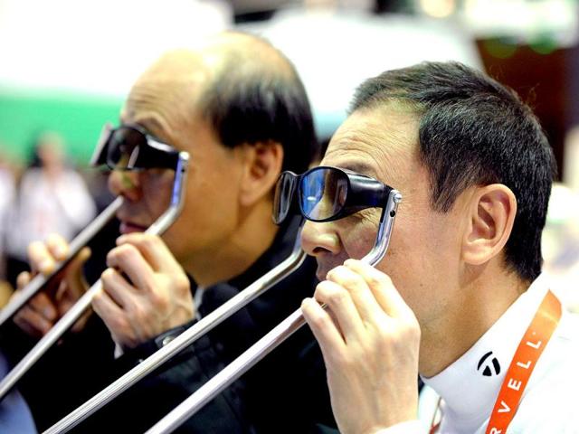 Conference-attendees-look-through-3D-glasses-at-the-TCL-booth-on-the-opening-day-of-the-International-Consumer-Electronics-Show-in-Las-Vegas-Nevada-David-Becker-Getty-Images-AFP