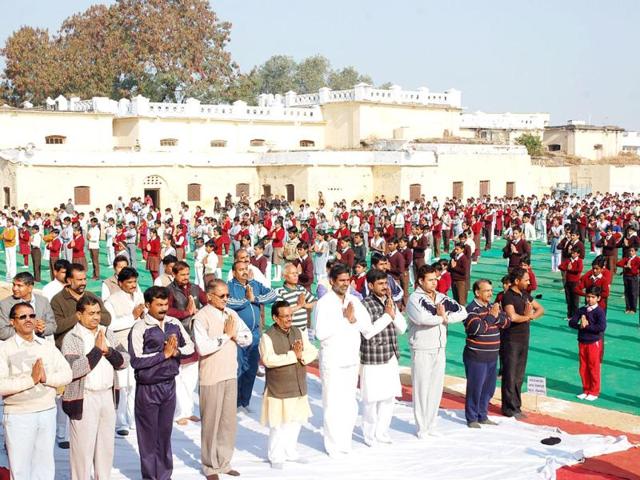 School children participate in a mass surya namaskar yoga exercise in Bhopal. (AFP Photo)