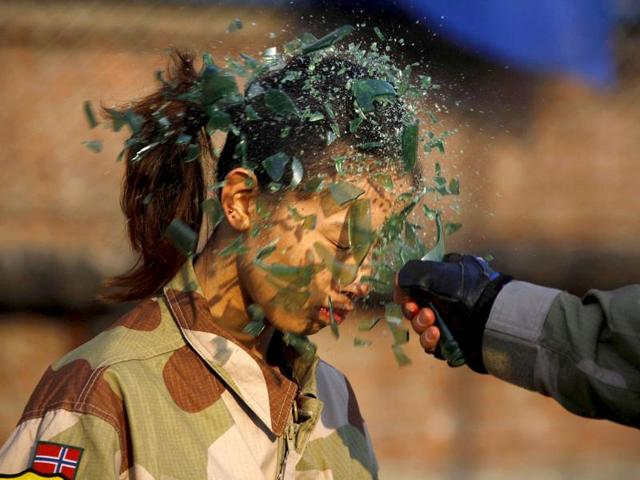 An instructor from the Tianjiao Special Guard/Security Consultant Ltd. Co, smashes a bottle over a female recruit's head during a training session for China's first female bodyguards in Beijing. (Reuters/David Gray)