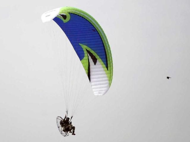 A soldier on a para motor flies past on the occasion of Army Day in New Delhi. AP Photo/Mustafa Quraishi.
