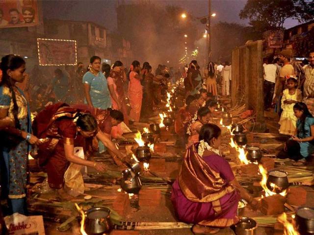 Pots in which pongal is being cooked is lined up by the residents of Dharavi as they participate in the rituals to celebrate Pongal in Mumbai. PTI Photo