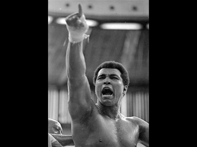 In-this-June-15-1975-file-photo-world-heavyweight-champion-Muhammad-Ali-shouts-Joe-Bugner-must-go-to-Malaysian-fans-during-a-training-session-for-his-fight-against-Bugner-in-Kuala-Lumpur-AP-Photo-File