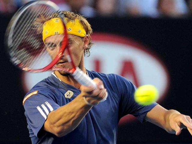 Alexander Kudryavtsev of Russia hits a return against Roger Federer of Switzerland in their first round men's singles match on day one of the 2012 Australian Open tennis tournament in Melbourne. AFP Photo