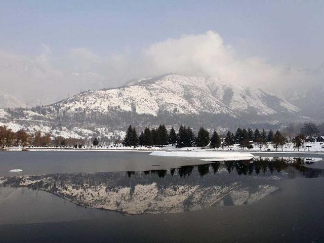 Snow-covered Zabarwan mountains are reflected in the waters of a local garden in Srinagar, Kashmir Valley. AP Photo/Mukhtar Khan
