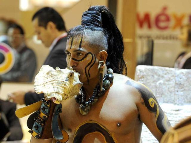 A Mexican Indian native blows a seashell in front of the Mexican stand during the inauguration of the International Tourism Trade Fair (FITUR) in Madrid. AFP photo