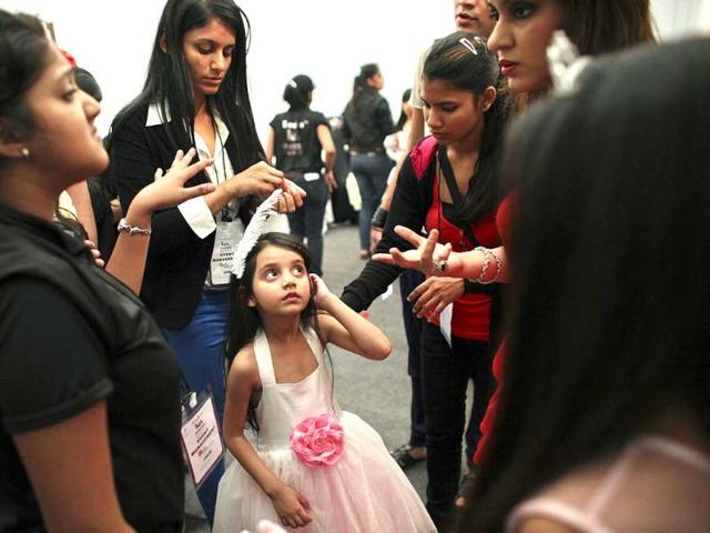 A child model receives directions backstage before a show at India Kids Fashion Week in Mumbai. Reuters/Danish Siddiqui.