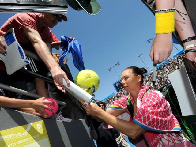 Vera Zvonareva of Russia signs autographs for supporters after victory in her women's singles match against Lucie Hradecka of Czech Republic on the fourth day of the Australian Open tennis tournament in Melbourne. Zvonereva won 6-1. 7-6.. (AFP Photo)