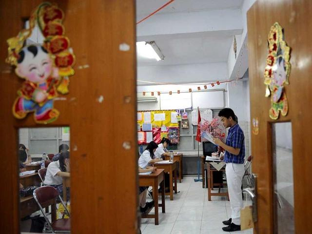 This picture shows Indonesian students studying Mandarin at a school in Jakarta. A troupe of lion dancers jerk and sway down a busy Jakarta street to usher in the Chinese New Year, moving to the beat of traditional instruments and handing out red envelopes inscribed with good wishes in Chinese characters. AFP Photo / Adek Berry