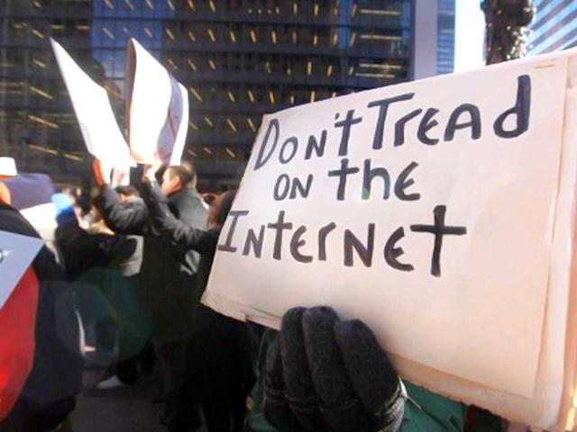Protesters-demonstrate-against-the-proposed-Stop-Online-Piracy-Act-SOPA-and-Protect-IP-Act-PIPA-outside-the-offices-of-US-Sen-Charles-Schumer-D-NY-and-US-Sen-Kirsten-Gillibrand-D-NY-in-New-York-City-The-controversial-legislation-is-aimed-at-preventing-piracy-of-media-but-those-opposed-believe-it-will-support-censorship-Mario-Tama-Getty-Images-AFP