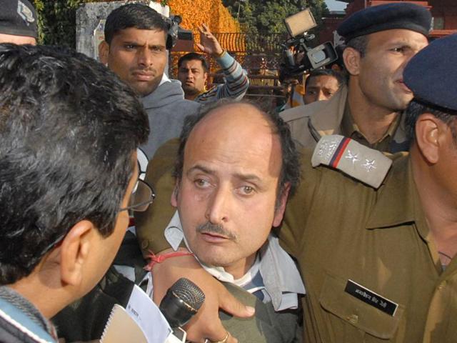 A-man-who-hurled-a-shoe-at-Team-Anna-members-at-a-public-meeting-being-taken-away-by-the-police-in-Dehradun-HT-photo-Rupesh-Kumar