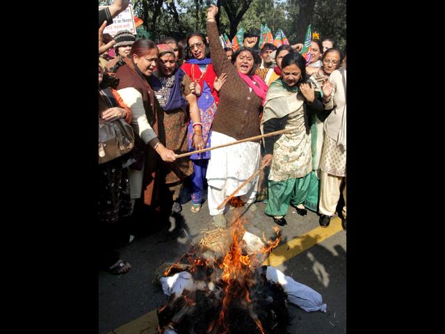 BJP women wing members raise slogans as they burn an effigy of Congress general secretary Rahul Gandhi during a protest over his remarks against party leader Uma Bharti, outside AICC headquarters in New Delhi. PTI Photo/Kamal Kishore