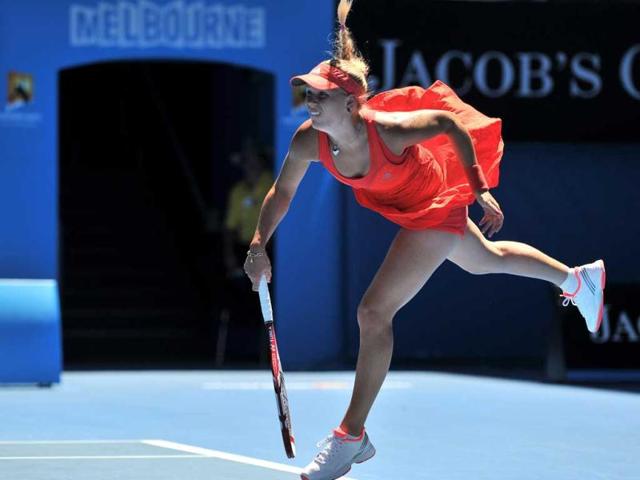 Caroline Wozniacki of Denmark serves against Kim Clijsters of Belgium in their women's singles quarter-final match on day nine of the 2012 Australian Open tennis tournament in Melbourne. AFP PHOTO / NICOLAS ASFOURI