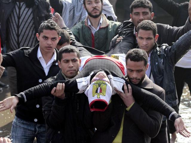 A demonstrator acts as a martyr to symbolize people killed during the revolution during a protest marking the first anniversary of Egypt's uprising at Tahrir square in Cairo. (REUTERS/Mohamed Abd El-Ghany)