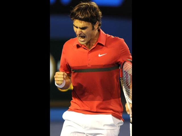 Roger Federer gestures as he celebrates winning the first set during his semifinal men's singles match against Rafael Nadal on the eleventh day of the Australian Open tennis tournament in Melbourne. AFP Photo/Greg Wood