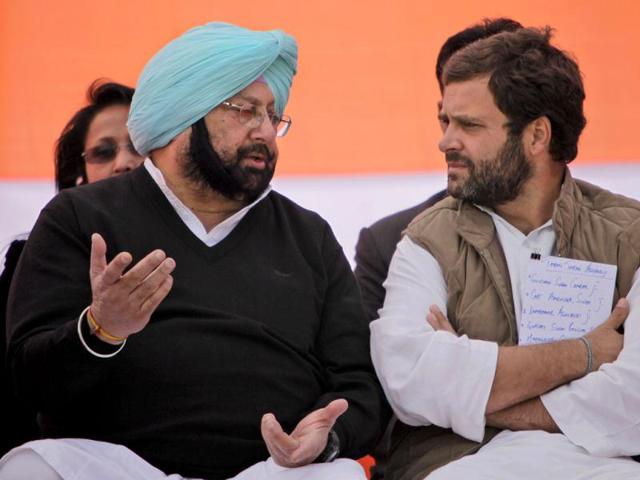 Congress general secretary Rahul Gandhi, speaks with former chief minister of Punjab state, Captain Amarinder Singh during an election rally in Chabal, near Amritsar. (AP Photo)