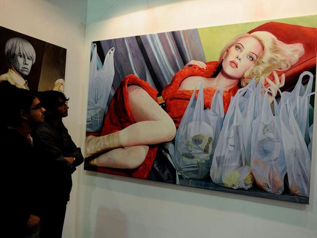 Visitors look at a painting by Greek artist Jannis Markopoulos at the India Art Fair in New Delhi. AFP Photo/ Sajjad Hussain