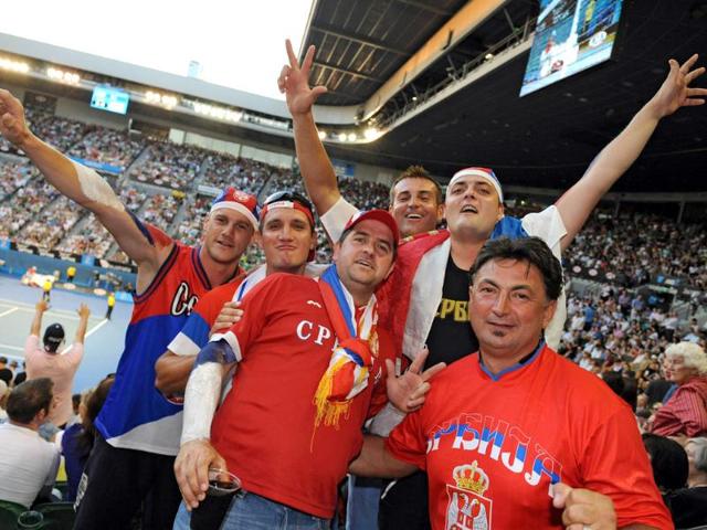 Supporters for Novak Djokovic pose in the stands as they cheer him on against Andy Murray in their men's singles semifinal match during the Australian Open tennis tournament in Melbourne. AFP Photo/Torsten Blackwood