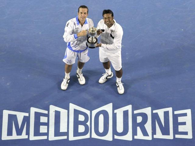 Leander Paes and Radek Stepanek of the Czech Republic hold the trophy during the awarding ceremony after defeating USA's Bob Bryan and Mike Bryan in their men's doubles final at the Australian Open tennis championship, in Melbourne. (AP Photo/John Donegan)