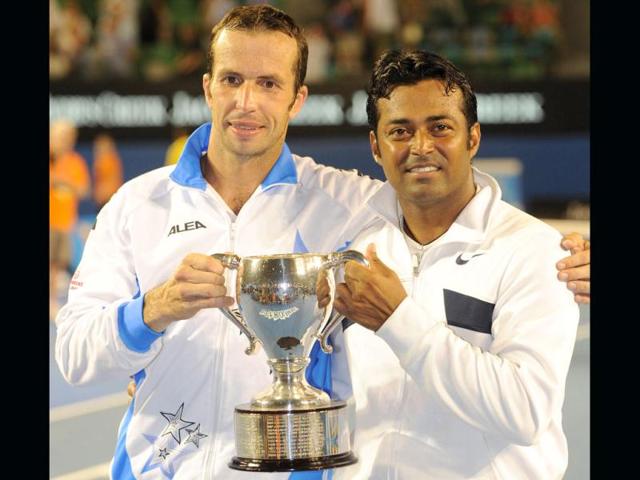 Leander Paes and Radek Stepanek of Czech Republic pose with the trophy after victory in their men's doubles final against Bob and Mike Bryan of the US at the Australian Open tennis tournament in Melbourne. (AFP photo /William West)