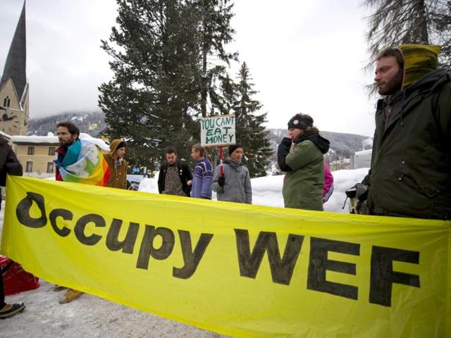 Members of "Occupy WEF" hold a demonstration against the World Economic Forum (WEF) annual meeting. (AFP PHOTO / FABRICE COFFRINI )