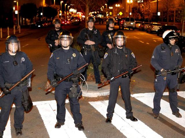 Oakland police block off a street in downtown Oakland during an Occupy Oakland protest in Oakland, Calif. Police were in the process of arresting about 100 Occupy protesters for failing to disperse Saturday night, hours after officers used tear gas on a rowdy group of demonstrators who threw rocks and flares at them and tore down fences. AP