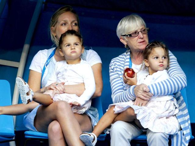 Charlene Riva and Myla Rose, twin daughters of Roger Federer, watch the men's singles match between their father and Alexander Kudryavtsev of Russia at the Australian Open tennis tournament in Melbourne. (Reuters)