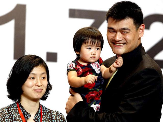 NBA player Yao Ming holds his daughter Qin Lei next to his wife Ye Li during a news conference to announce his retirement from basketball, in Shanghai. (Reuters)