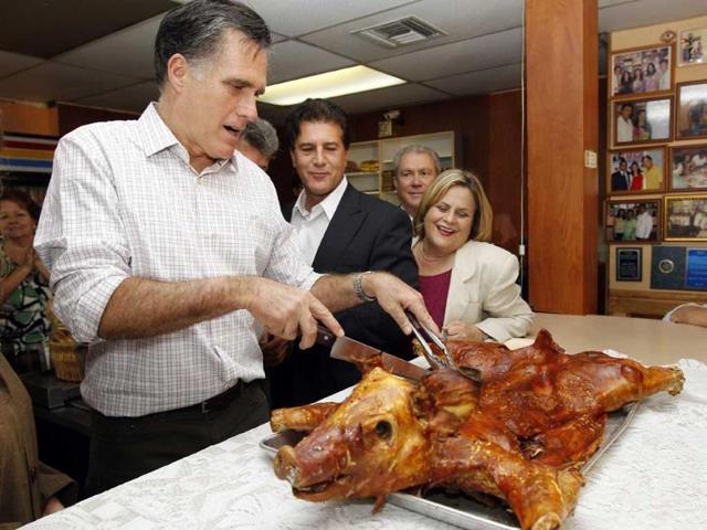 Republican presidential candidate, former Massachusetts gov Mitt Romney, slices a roast pig as he campaigns at Casa Marin restaurant in Hialeah. AP Photo/Charles Dharapak