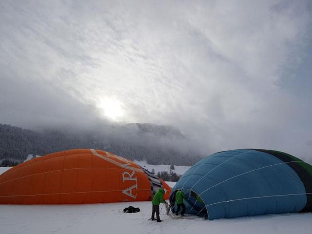 Balloonists prepare their hot air balloons in the Swiss Alps resort of Chateau d'Oex during the 34th International Balloon Festival. AFP Photo / Yuri Kadobnov Balloonists prepare their hot air balloons in the Swiss Alps resort of Chateau d'Oex during the 34th International Balloon Festival. AFP Photo / Yuri Kadobnov