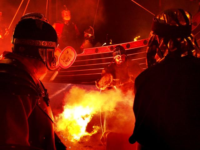Members of the Jarl Squad are pictured in front of a burning Viking Galley in Lerwick, on the Shetland Isles, off the north-east coast of Scotland, during the Up Helly Aa Viking festival. (AP Photo/Danny Lawson)