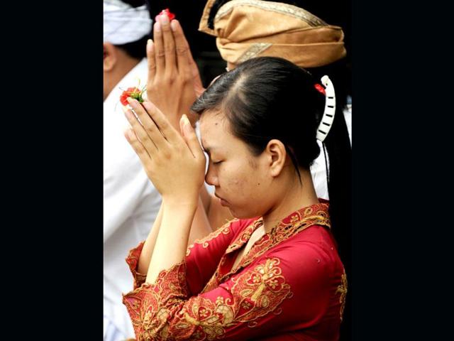 A Balinese Hindu prays as she celebrates the religious festival of Galungan at Jagatnatha temple in Singaraja, on the Hindu majority island of Bali. Galungan, based on the Hindu saka calendar, is the most important festival in Bali and symbolizes the victory of Virtue (Dharma) upon Evil (Adharma). AFP Photo /Sonny Tumbelaka