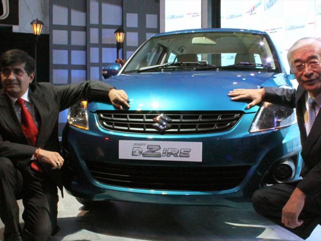 Managing director and CEO of Maruti Suzuki India Shinzo Nakanishi (L) and executive director of Maruti Suzuki India Mayank Pareek (R) pose with newly unveiled Swift DZire in New Delhi. HT/Sunil Saxena
