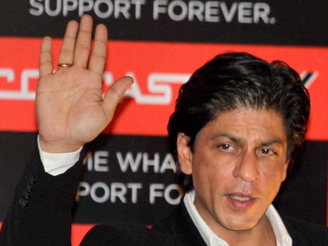 The superstar waves to the public.
