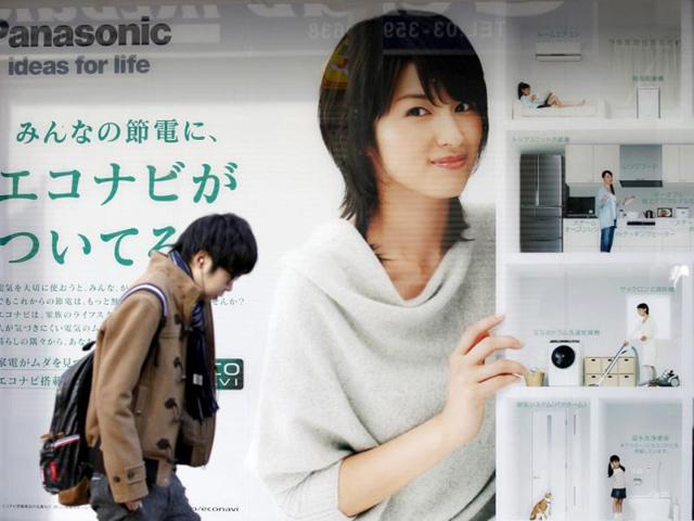 A man walks past an advertisement board of Panasonic outside an electronic shop in Tokyo. Panasonic Corp is likely to forecast a record net annual loss of more than $9.2 billion, local media reported, as it tallies the cost of trying to fix its broken TV unit and writes down its Sanyo Electric acquisition, joining a trinity of beleaguered Japanese consumer electronic giants. REUTERS/Kim Kyung-Hoon