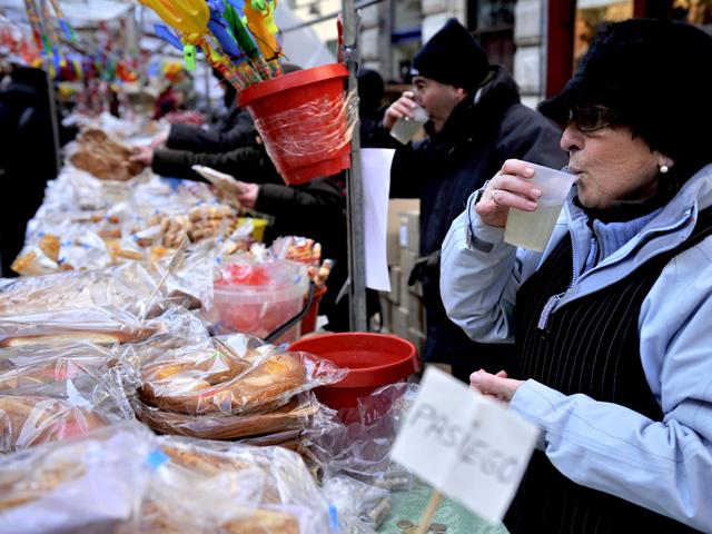 A woman drinks soup during Saint Blas Day, a day which people buy sweets blessed to protect their health, in Pamplona, northern Spain. (AP Photo/Alvaro Barrientos)