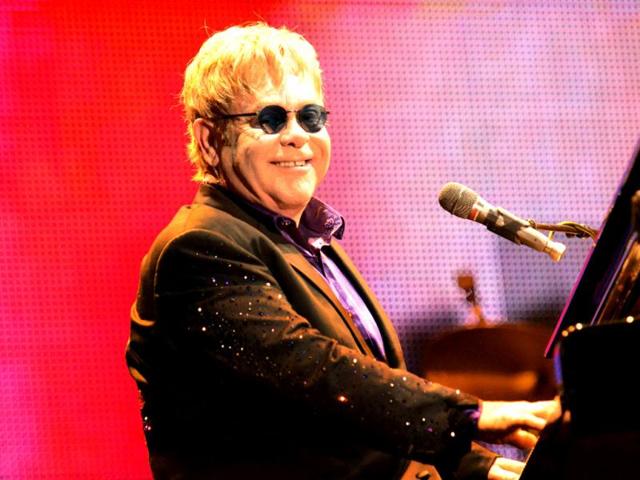 Legendary English singer Elton John performs with his band during his latest tour at the Ricardo Saprissa Stadium in the capital city of San Jose, Costa Rica. AFP PHOTO/Ezequiel BECERRA