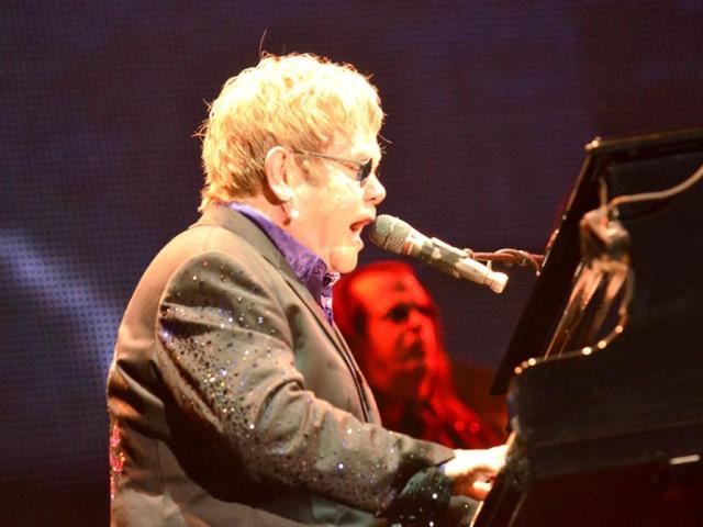 Legendary English singer Elton John performs with his band during his latest tour at the Ricardo Saprissa Stadium in the capital city of San Jose, Costa Rica. AFP PHOTO/Ezequiel BECERRA