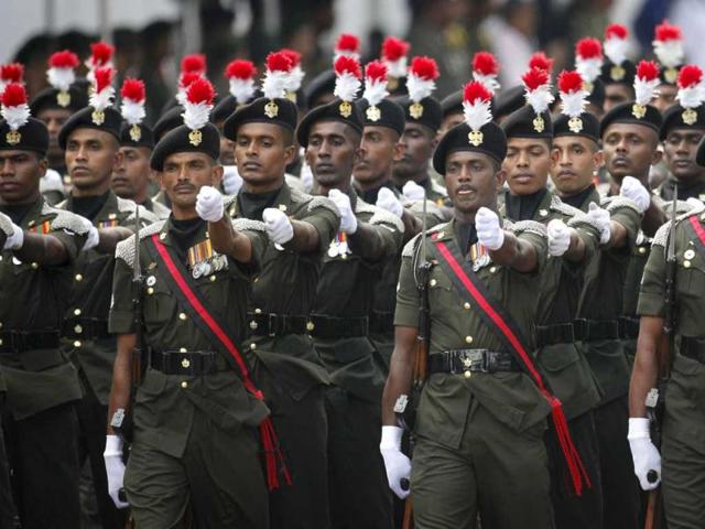 Sri Lanka army soldiers march during a parade celebrating Sri Lanka's 64th Independence Day, marking the country's independence from British colonial rule in 1948, in Anuradhapura, about 80 kilometers (50 miles) north of Colombo, Sri Lanka. AP