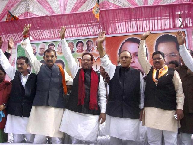 BJP senior leaders Arun Jaitley (2nd R) and Mukhtar Abbas Naqvi (C) with party leaders wave to the crowd at an election rally in Rampur. PTI Photo