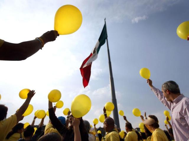 People hold up yellow balloons as they commemorate World Cancer Day at Zocalo Square in Mexico City. 5,298 people formed a human chain during the event, according to the organisers. Reuters/Edgard Garrido
