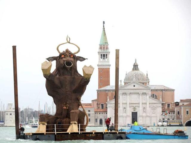 A sculpture of bull, symbolising the 2012 Venice carnival and inspired by ancient rites of the Venetian lagoon, is carried on the boat in front of St Mark's square in Venice. AFP photo