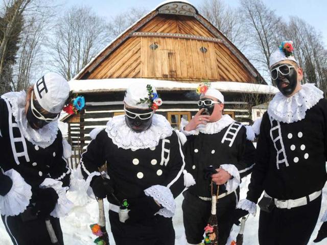 Men dressed in traditional chimney sweeper costumes smoke cigarettes during the traditional Czech Masopust carnival, near the east Bohemian city of Pardubice. AFP photo