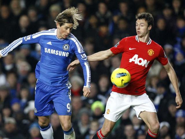 Chelsea's Fernando Torres (L) vies for the ball with Manchester United's Jonny Evans during their English Premier League soccer match at Chelsea's Stamford Bridge Stadium in London. AP Photo/Kirsty Wigglesworth
