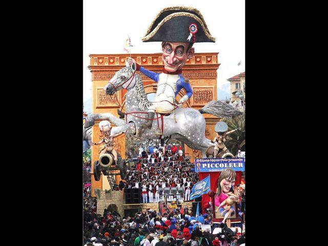 A carnival float called 'Grandeur' showing French President Nicolas Sarkozy dressed as Napoleon on a horse with Italian Prime Minister Mario Monti (L) and German chancellor Angela Merkel sat on cannons parade during the carnival in Viareggio. AFP/Fabio Muzzi