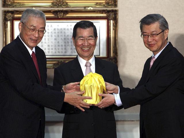 New Taiwanese Premier Sean Chen, right, receives the honorary seal from outgoing Premier Wu Den-yih, left, and vice President Vincent Siew in Taipei, Taiwan. AP/Chiang Ying-ying