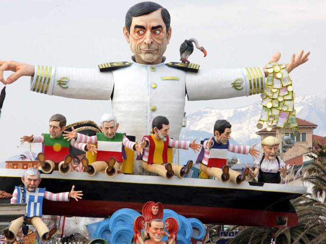 A carnival float called "But, where is the crisis ?" showing the head of the European Central Bank Mario Draghi (top) and European leaders parades during the carnival in Viareggio. AFP PHOTO/Fabio Muzzi