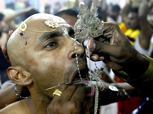 Devotee Guna, 37, has his tongue pierced during the Thaipusam festival in Singapore. Thaipusam, a Hindu festival observed on the day of the full moon during the Tamil month of Thai, is celebrated in honour of Lord Murugan. REUTERS/Edgar Su